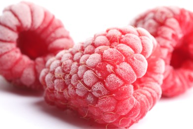 Photo of Frozen raspberries on white background, macro view
