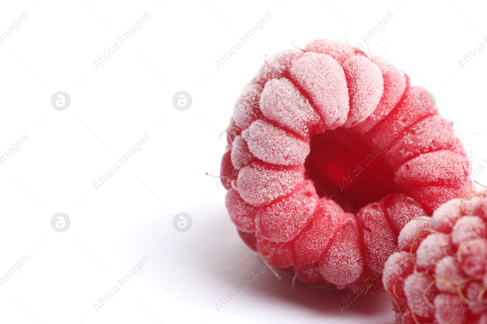 Photo of Frozen raspberries on white background, macro view. Space for text