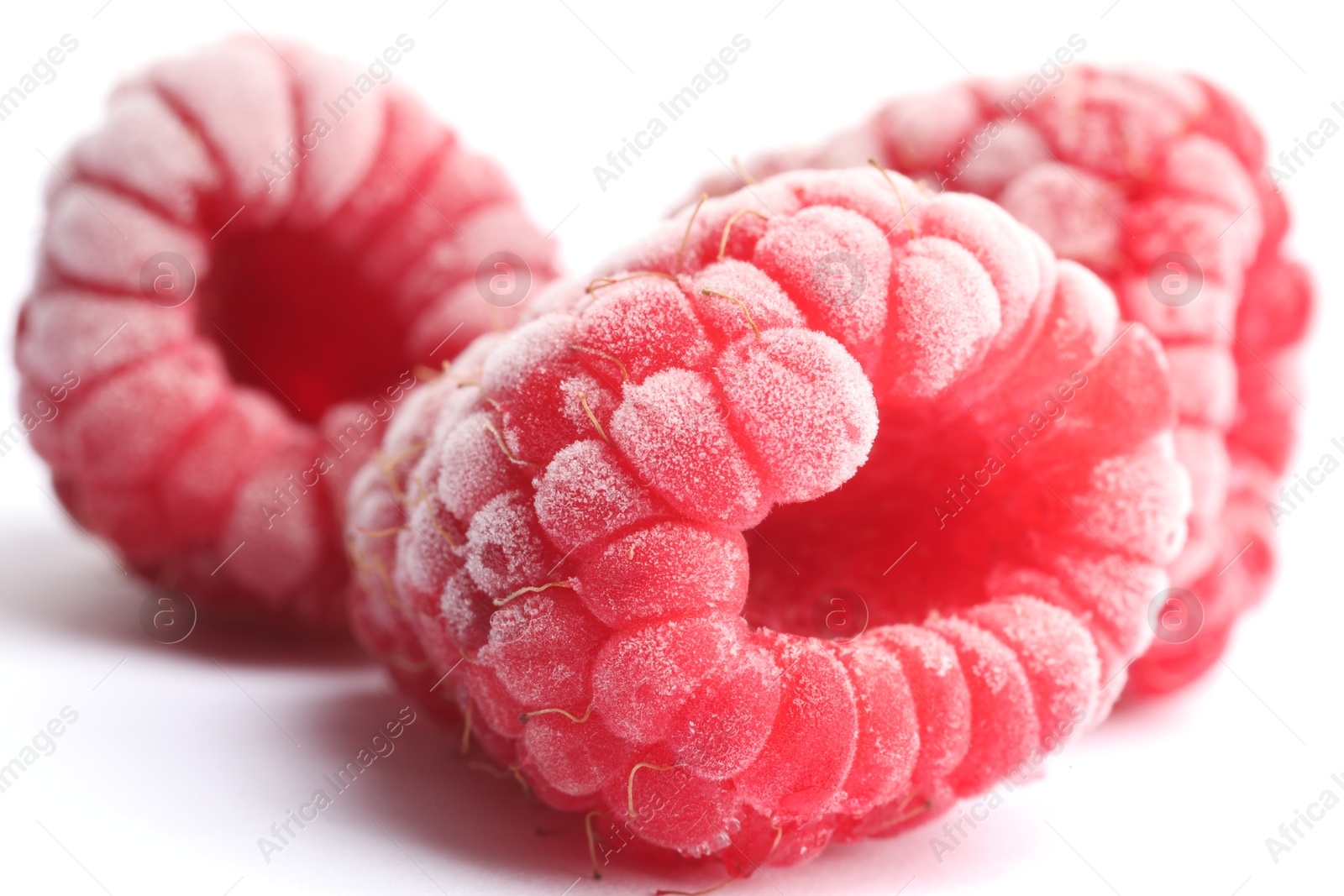 Photo of Frozen raspberries on white background, macro view