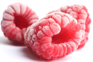 Photo of Frozen raspberries on white background, macro view