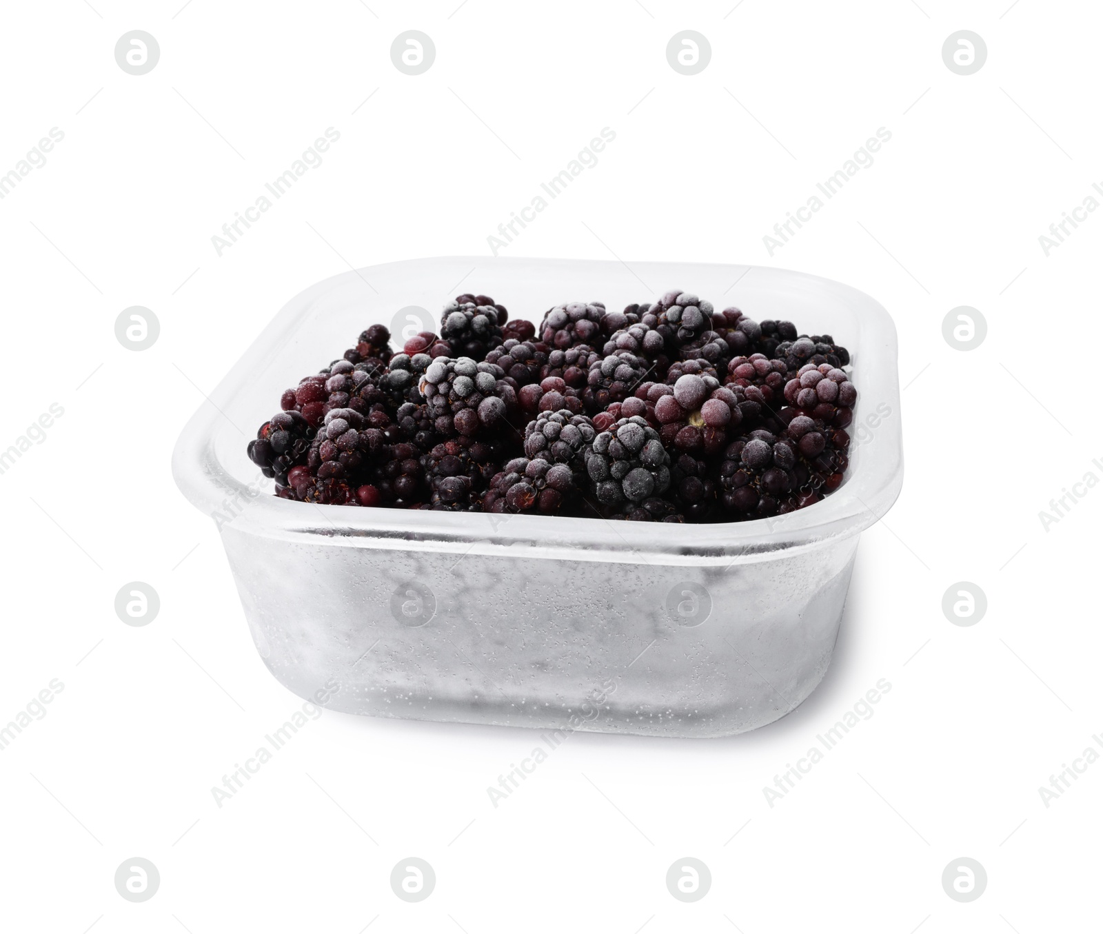 Photo of Frozen blackberries in glass container isolated on white