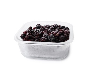 Photo of Frozen blackberries in glass container isolated on white