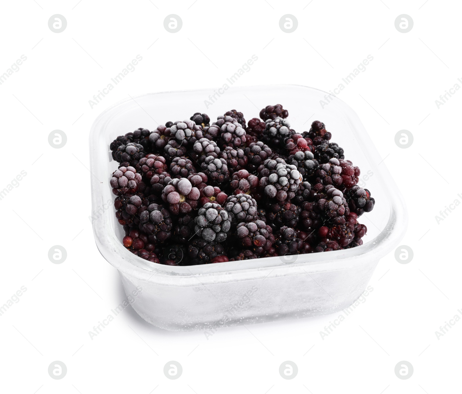 Photo of Frozen blackberries in glass container isolated on white