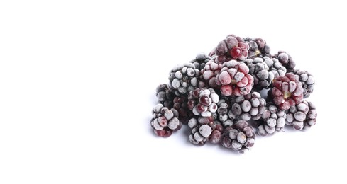 Photo of Heap of frozen blackberries on white background, space for text