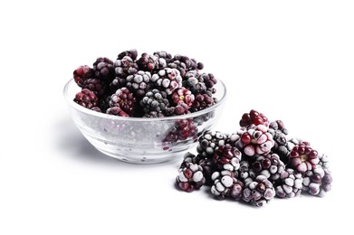 Photo of Many ripe frozen blackberries isolated on white