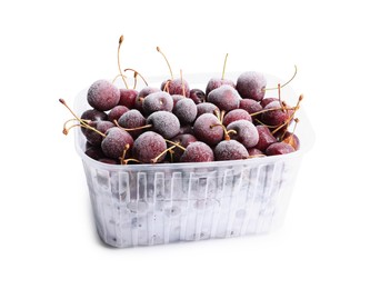 Photo of Frozen cherries in plastic container isolated on white