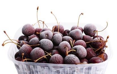 Photo of Frozen cherries in plastic container isolated on white