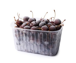 Photo of Frozen cherries in plastic container isolated on white