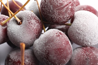 Photo of Many frozen cherries on white background, closeup