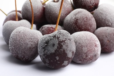 Photo of Many frozen cherries on white background, closeup