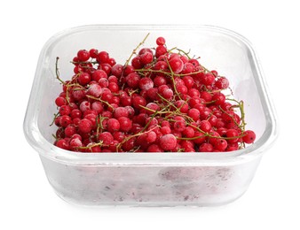 Photo of Frozen currants in glass container isolated on white