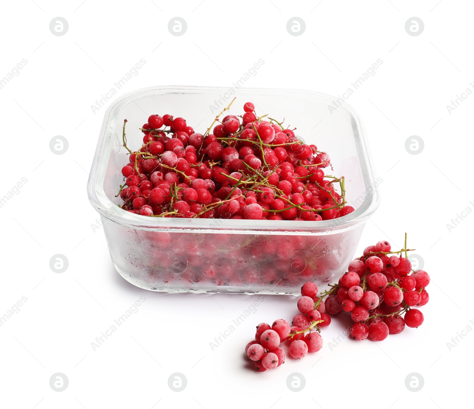 Photo of Frozen currants in glass container isolated on white