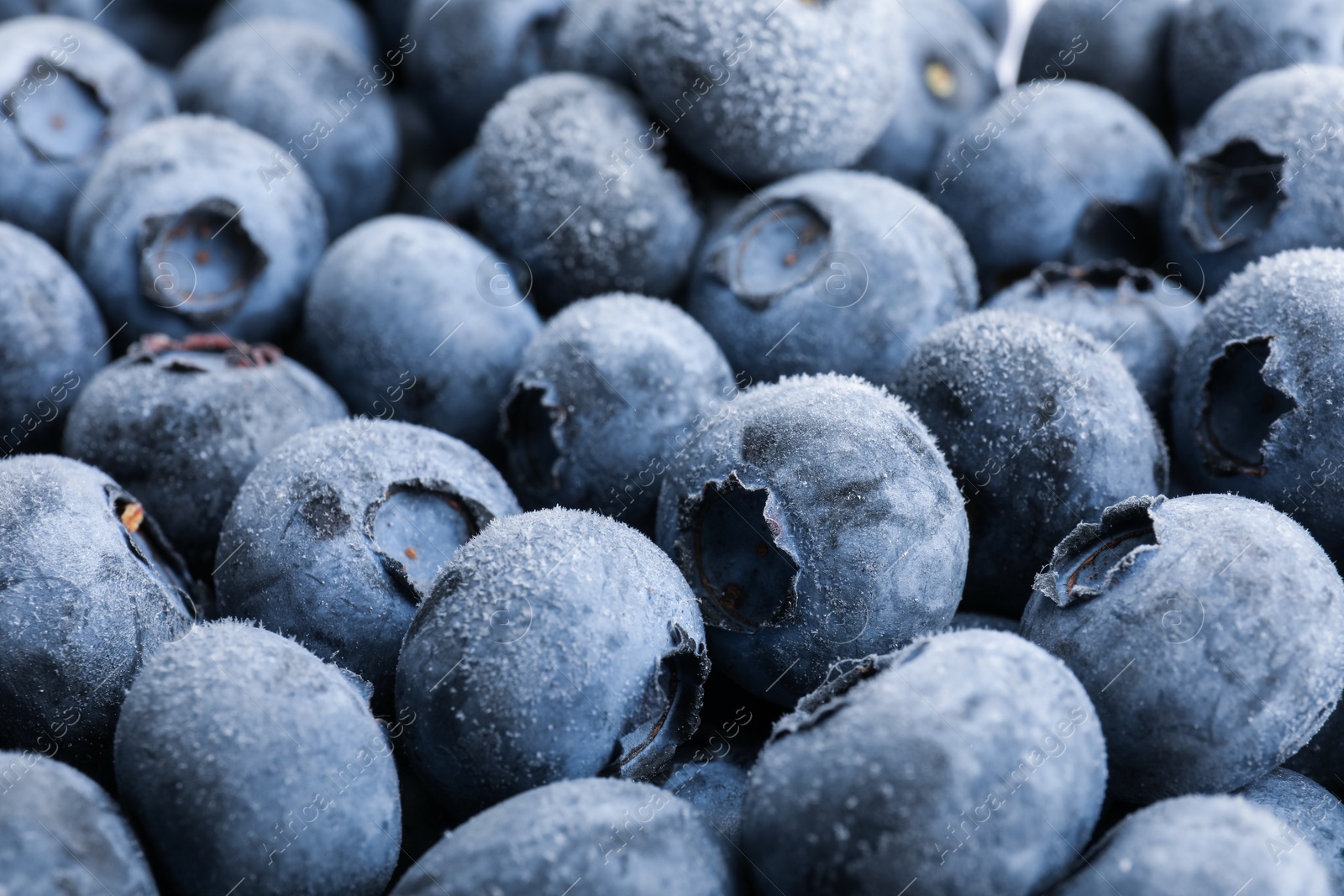 Photo of Heap of frozen blueberries as background, closeup