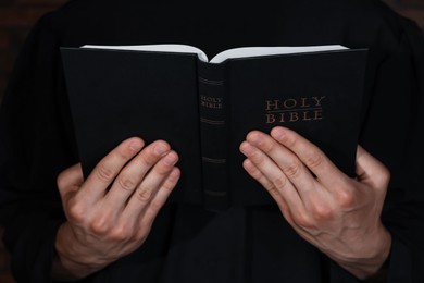 Photo of Priest with open Holy Bible, closeup view