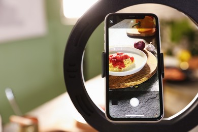 Photo of Shooting tasty pasta and ingredients with smartphone in studio, selective focus. Professional food photography
