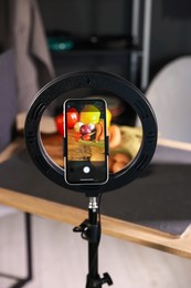 Photo of Shooting vegetables with smartphone in studio, focus on screen. Professional food photography