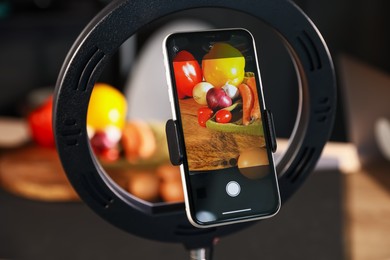 Photo of Shooting vegetables with smartphone in studio, focus on screen. Professional food photography