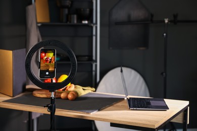 Photo of Shooting vegetables with smartphone in studio, focus on screen. Professional food photography