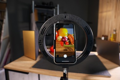 Photo of Shooting vegetables with smartphone in studio, focus on screen. Professional food photography