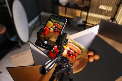 Photo of Shooting vegetables with smartphone in studio, focus on screen. Professional food photography