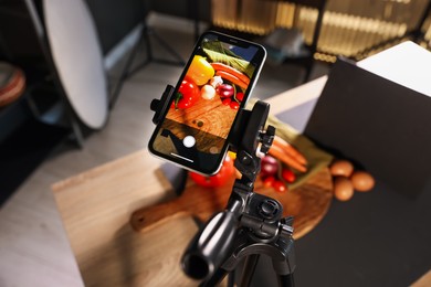 Photo of Shooting vegetables with smartphone in studio, focus on screen. Professional food photography