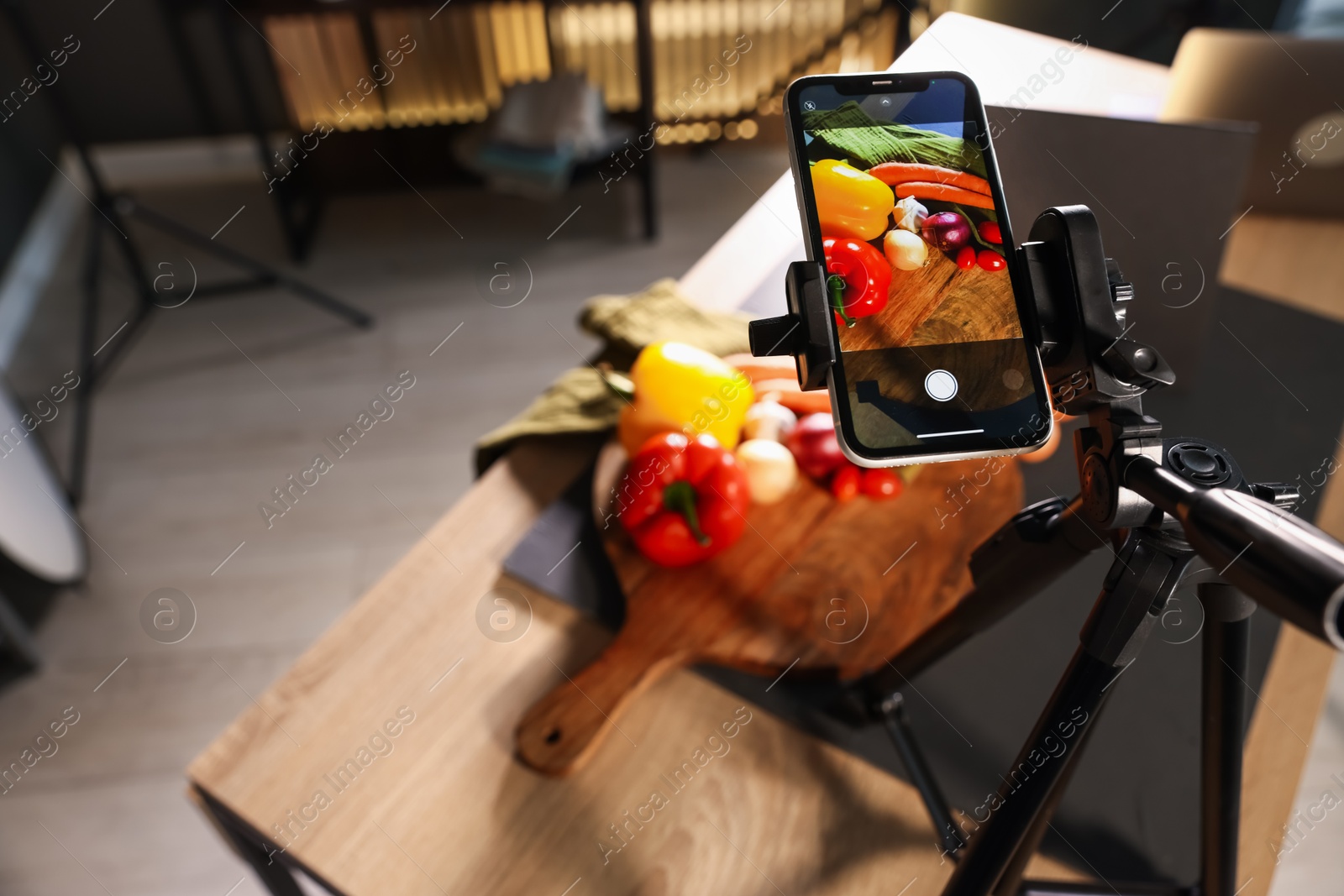 Photo of Shooting vegetables with smartphone in studio, focus on screen. Professional food photography