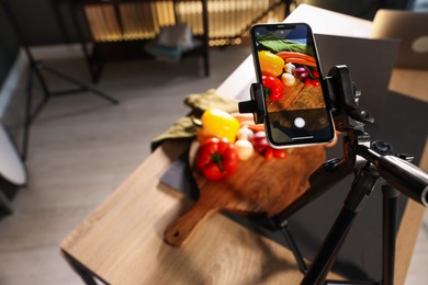 Photo of Shooting vegetables with smartphone in studio, focus on screen. Professional food photography