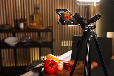 Photo of Shooting vegetables with smartphone in studio, selective focus. Professional food photography