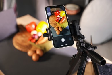 Photo of Shooting vegetables with smartphone in studio, selective focus. Professional food photography