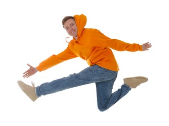Photo of Portrait of happy young man jumping on white background