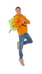 Photo of Portrait of happy young man with backpack jumping on white background
