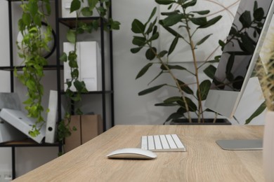 Photo of Biophilic interior design. Stylish workplace with computer and houseplants in office