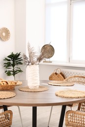 Photo of Stylish table with chairs and decor in dining room. Interior design