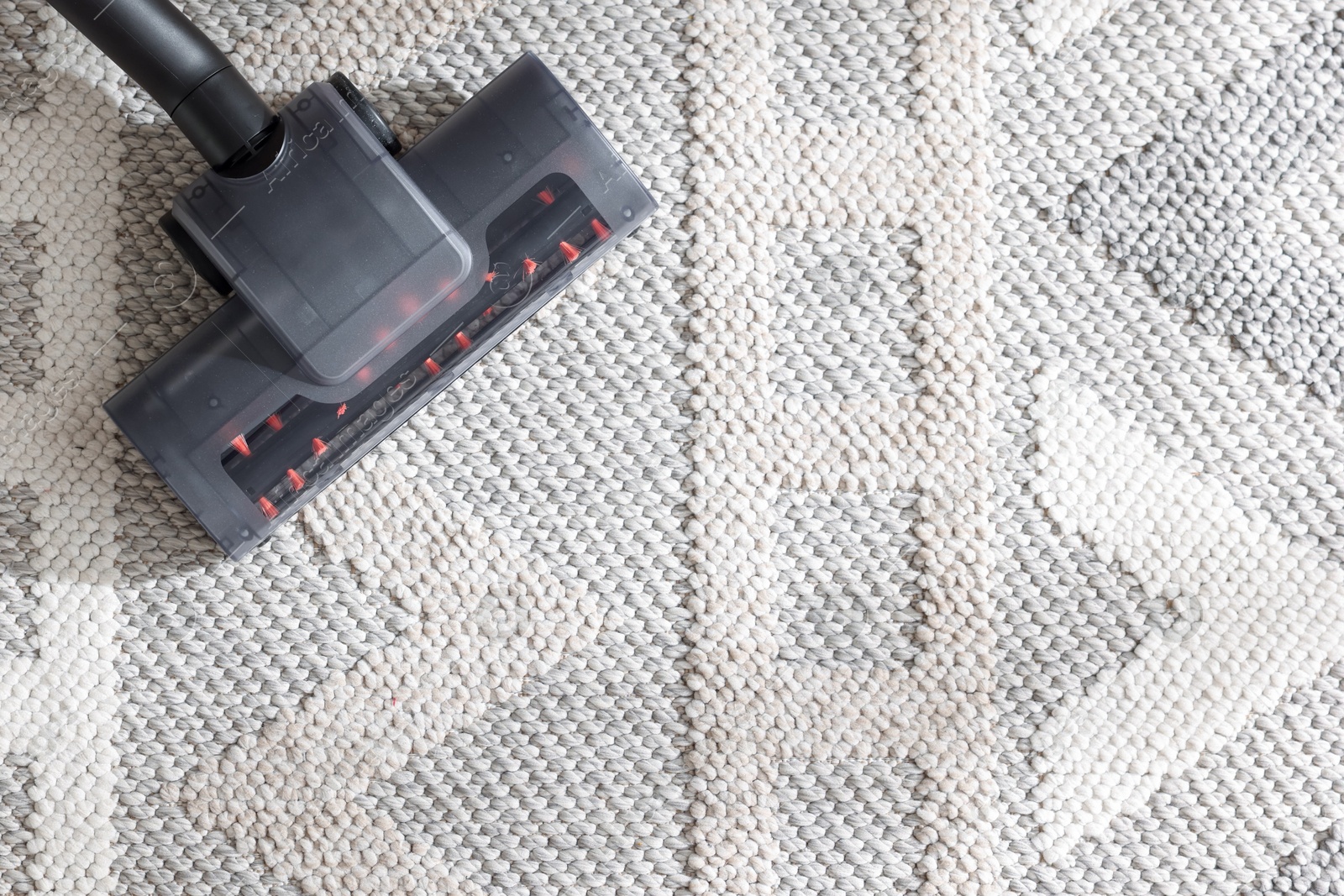 One vacuum cleaner nozzle on carpet, top view. Space for text Photo of One vacuum cleaner nozzle on carpet, top view. Space for text