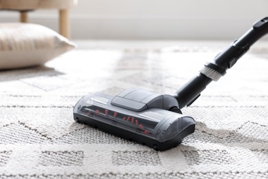 Photo of One vacuum cleaner nozzle on carpet indoors, closeup