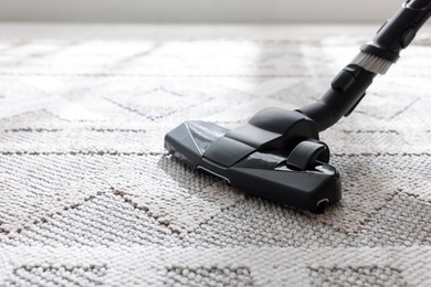 Photo of One vacuum cleaner nozzle on carpet indoors, closeup. Space for text