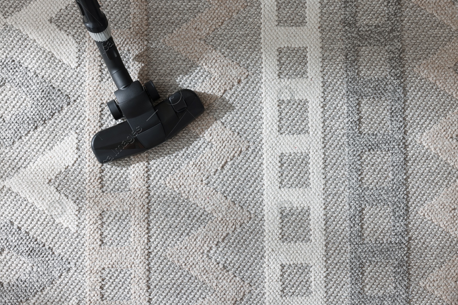 One vacuum cleaner nozzle on carpet, top view. Space for text Photo of One vacuum cleaner nozzle on carpet, top view. Space for text