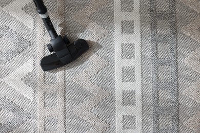 Photo of One vacuum cleaner nozzle on carpet, top view. Space for text