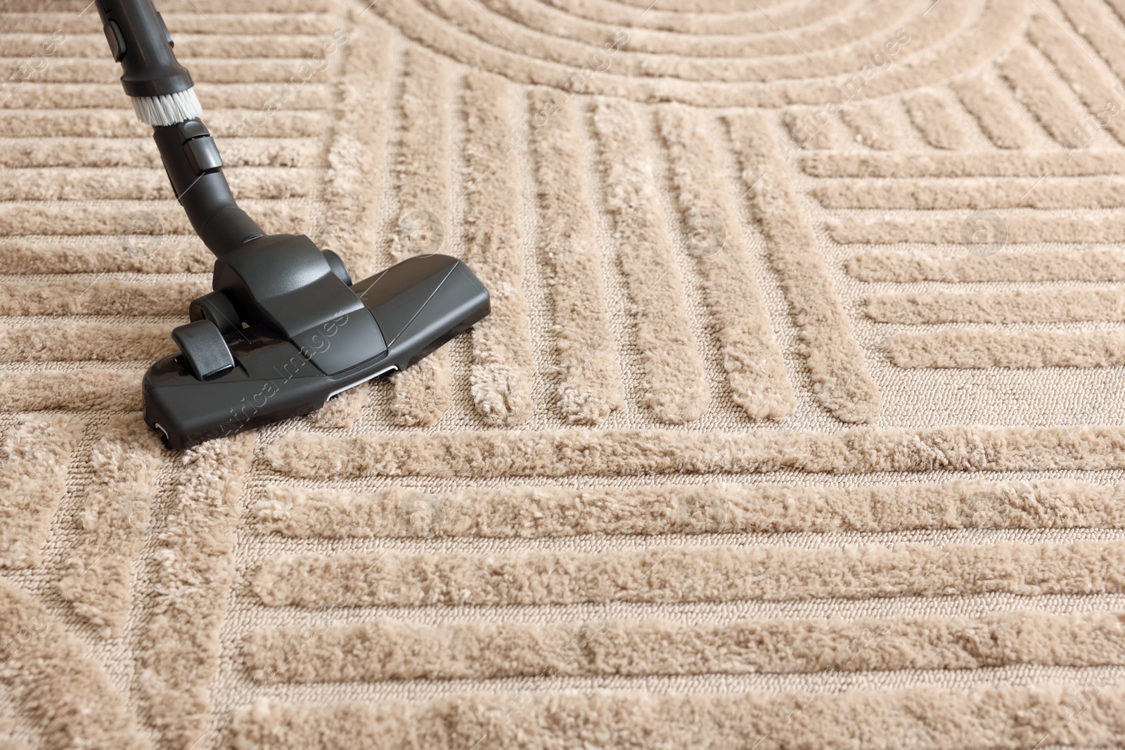 One vacuum cleaner nozzle on carpet, space for text Photo of One vacuum cleaner nozzle on carpet, space for text