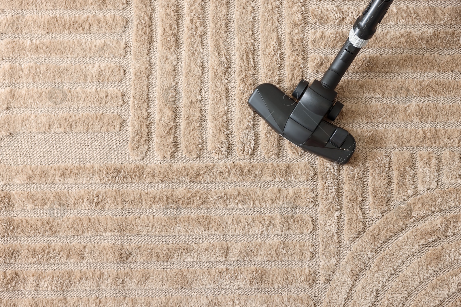 One vacuum cleaner nozzle on carpet, top view. Space for text Photo of One vacuum cleaner nozzle on carpet, top view. Space for text