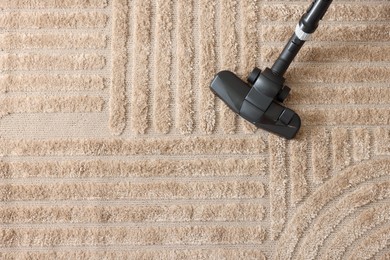 Photo of One vacuum cleaner nozzle on carpet, top view. Space for text