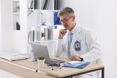Photo of Telemedicine. Doctor having video call with patient via laptop indoors