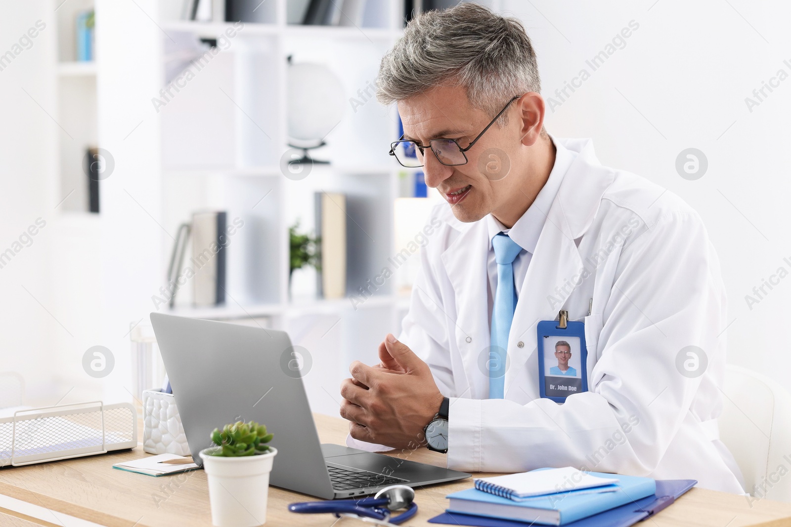 Photo of Telemedicine. Doctor having video call with patient via laptop indoors
