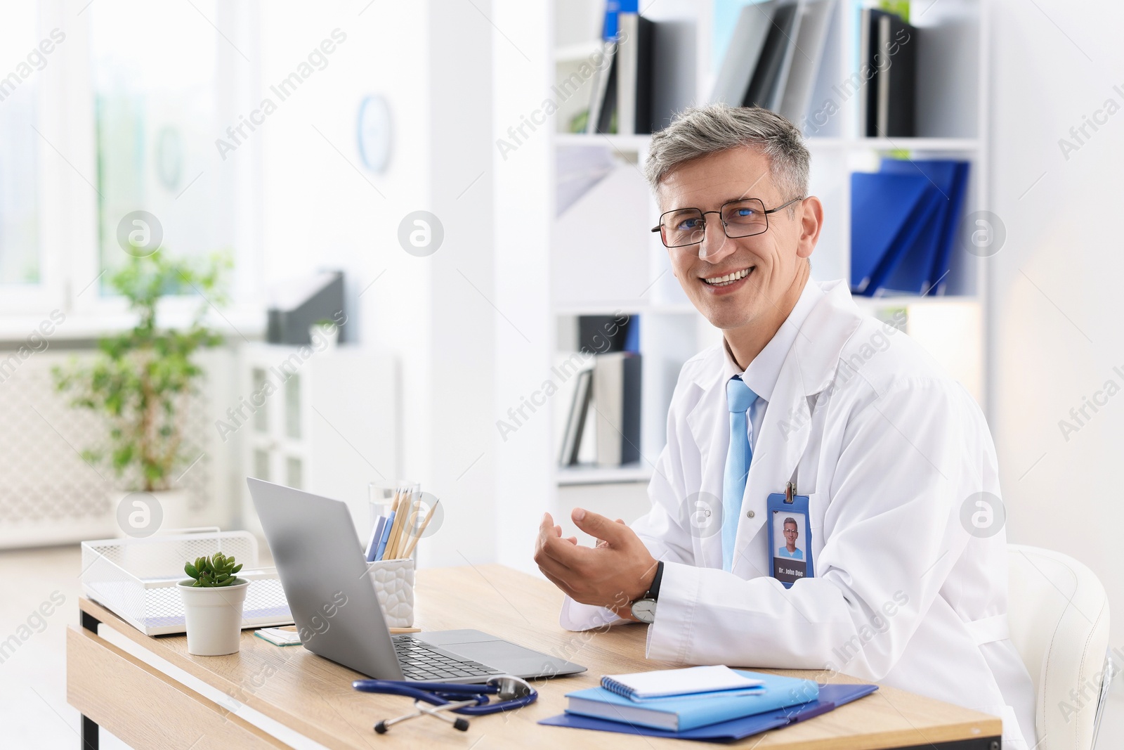 Photo of Telemedicine. Doctor having video call with patient via laptop indoors