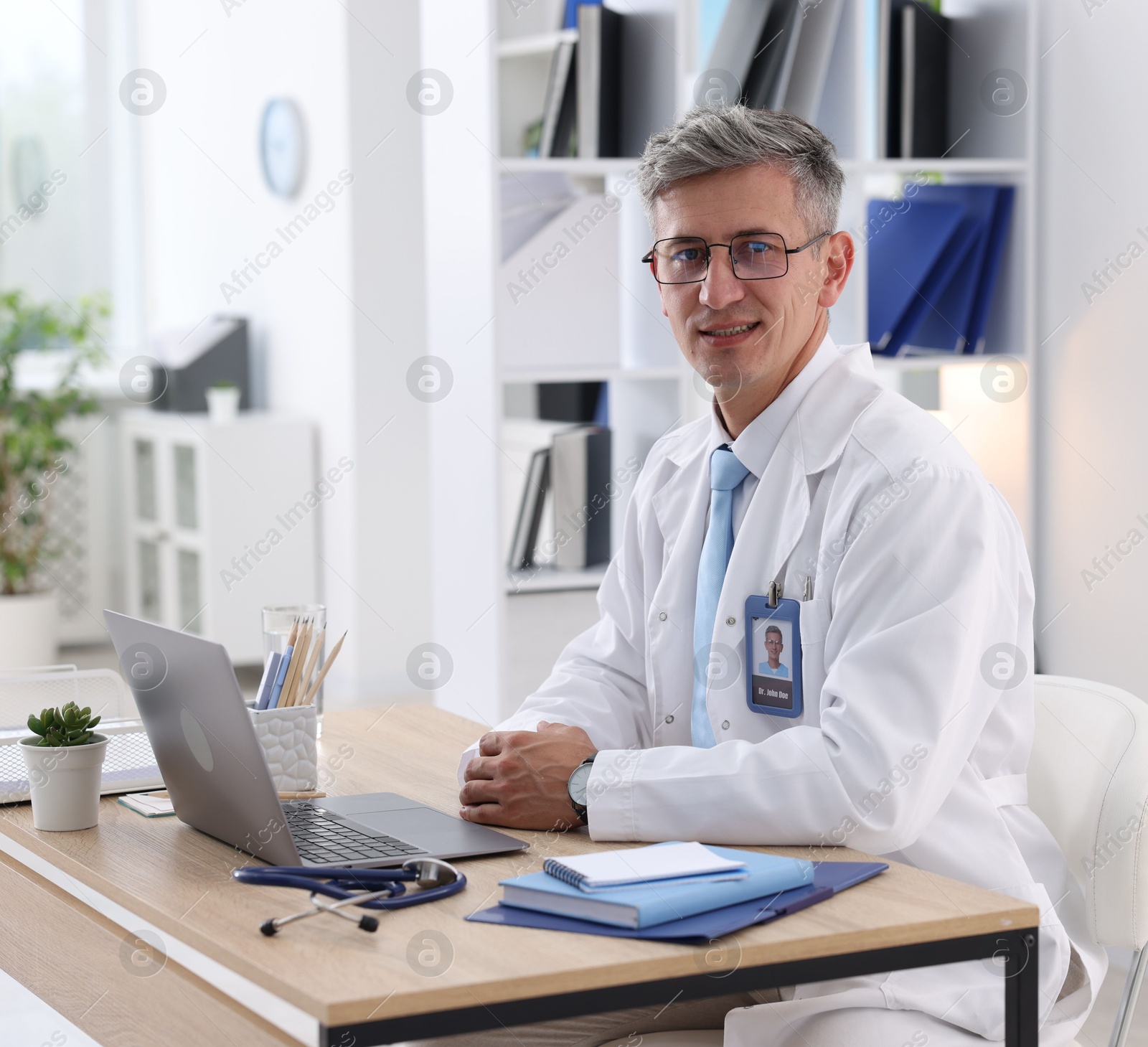 Photo of Telemedicine. Doctor having video call with patient via laptop indoors