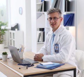 Photo of Telemedicine. Doctor having video call with patient via laptop indoors