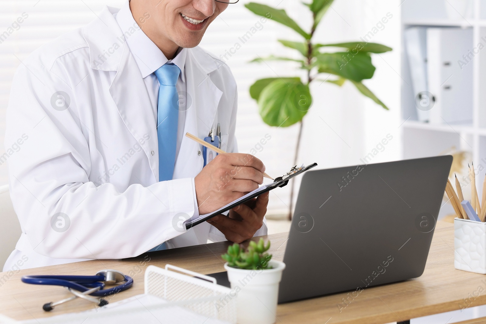 Photo of Telemedicine. Doctor having video call with patient via laptop indoors, closeup