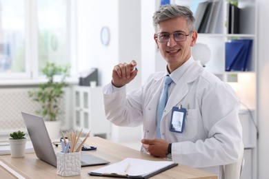 Photo of Telemedicine. Doctor having video call with patient via laptop indoors