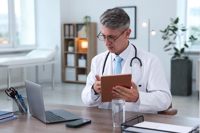 Photo of Telemedicine. Doctor having video call with patient via laptop indoors