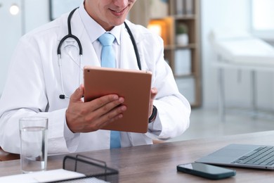 Photo of Telemedicine. Doctor having video call with patient via tablet indoors, closeup